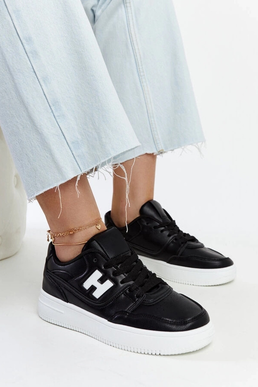 Sorte sneakers på en hvid platform... Sorte sneakers på en hvid platform...