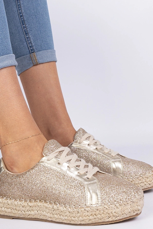 Gouden dames espadrilles versierd met... Gouden dames espadrilles versierd met...