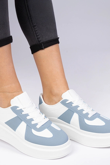 Blauwe sneakers op een... 2