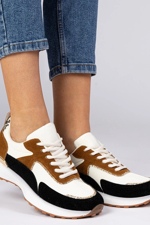 Wit-zwarte dames sneakers met... Wit-zwarte dames sneakers met...