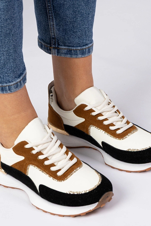 Wit-zwarte dames sneakers met... Wit-zwarte dames sneakers met...