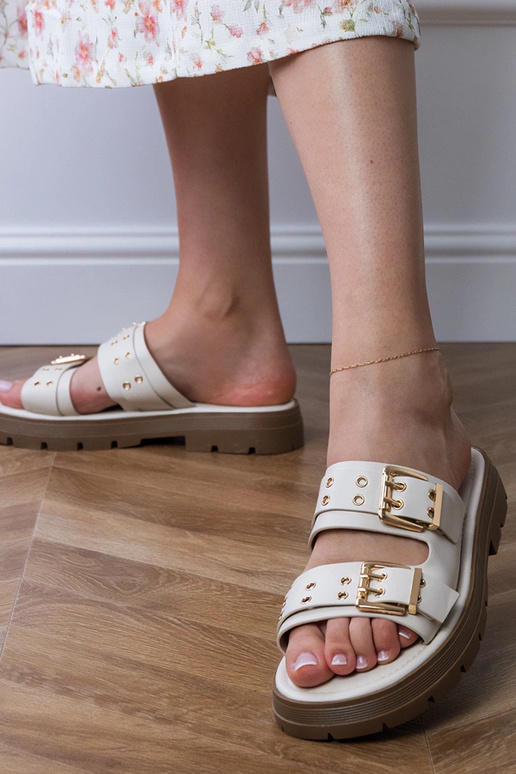 Zandkleurige platte slippers met... Zandkleurige platte slippers met...