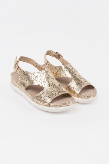 Gouden sandalen op een... 2