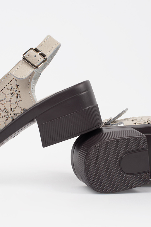 Zandkleurige open sandalen op een... Zandkleurige open sandalen op een...