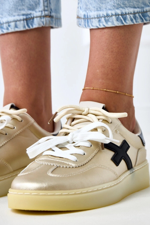 Gouden sneakers op platform met... Gouden sneakers op platform met...
