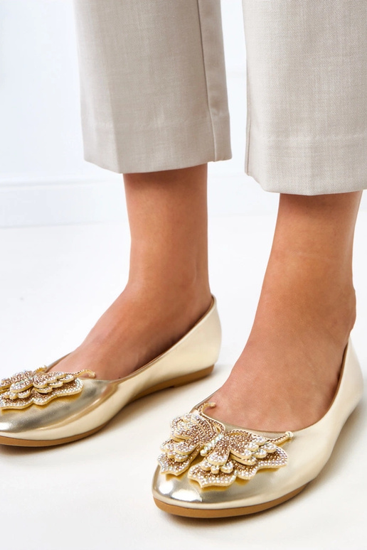 Gouden ballerina's met decoratieve... Gouden ballerina's met decoratieve...