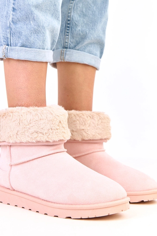 Roze sneeuwlaarzen met bont op een...