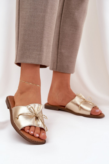 Gouden platte slippers met decoratieve strik Deonelis