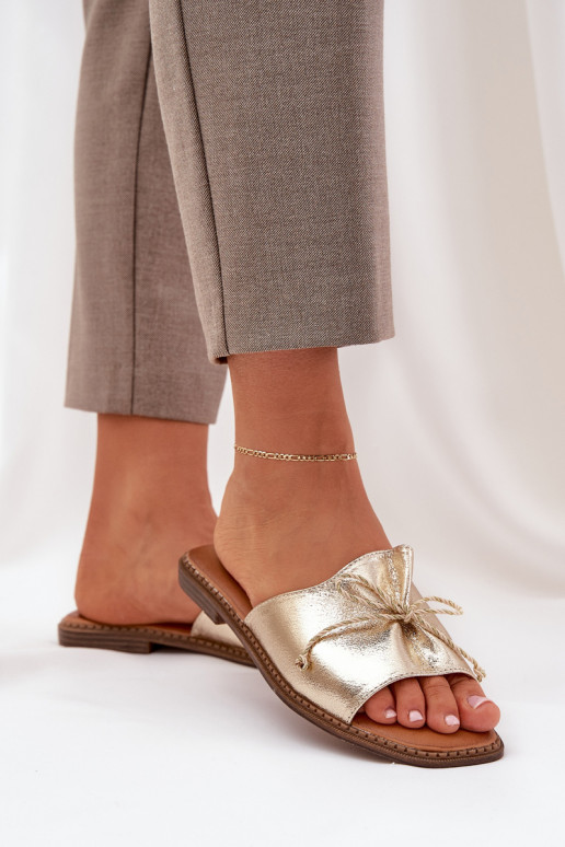 Gouden platte slippers met decoratieve strik Deonelis